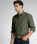 Men wearing green crush linen check shirt with rolled sleeves and denim jeans