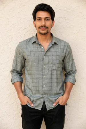 Men wearing grey crush linen check shirt with rolled sleeves and denim jeans