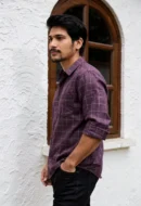 Men wearing burgundy crush linen check shirt with rolled sleeves and denim jeans