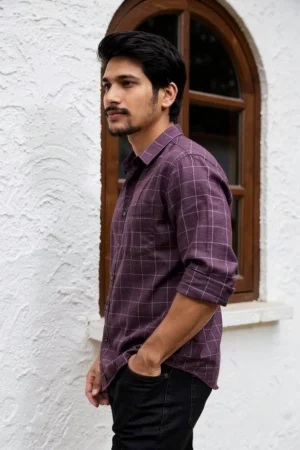 Men wearing burgundy crush linen check shirt with rolled sleeves and denim jeans